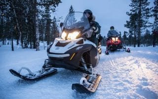 A pair of snowmobilers trek their way through the country side during their Manitoba winter getaway.