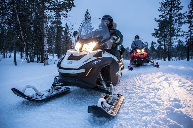 A pair of snowmobilers trek their way through the country side during their Manitoba winter getaway.