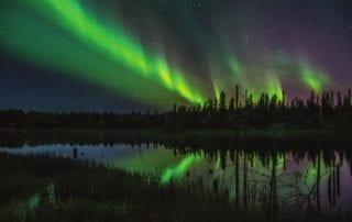 Manitoba vacations are the perfect time to see the northern lights as shown in this picture.