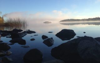 The mist rolls off the surface of Lake Athapapuskow.
