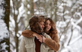 A young couple embrace during a romantic winter getaway in Manitoba.