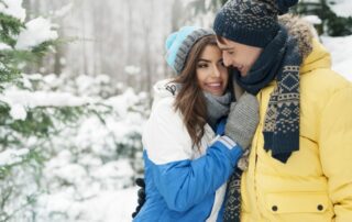 Couples Getaway Manitoba: A young couple embrace during a romantic winter getaway in Northern Manitoba's Bakers Narrows Lodge.